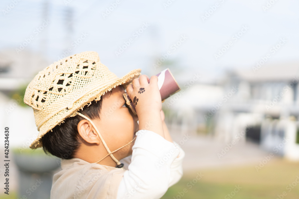 asian kid boy looking up to sky in jungle.Adventure.Staycation outdoor