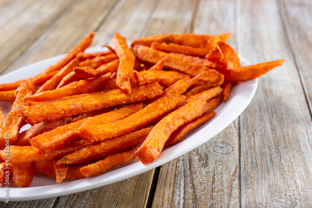 A view of a plate of sweet potato fries.