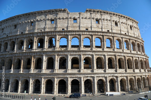 Ancient roman Colosseum in a sunny day. Facade of the famous Roman amphitheater. Ancient architecture and art.