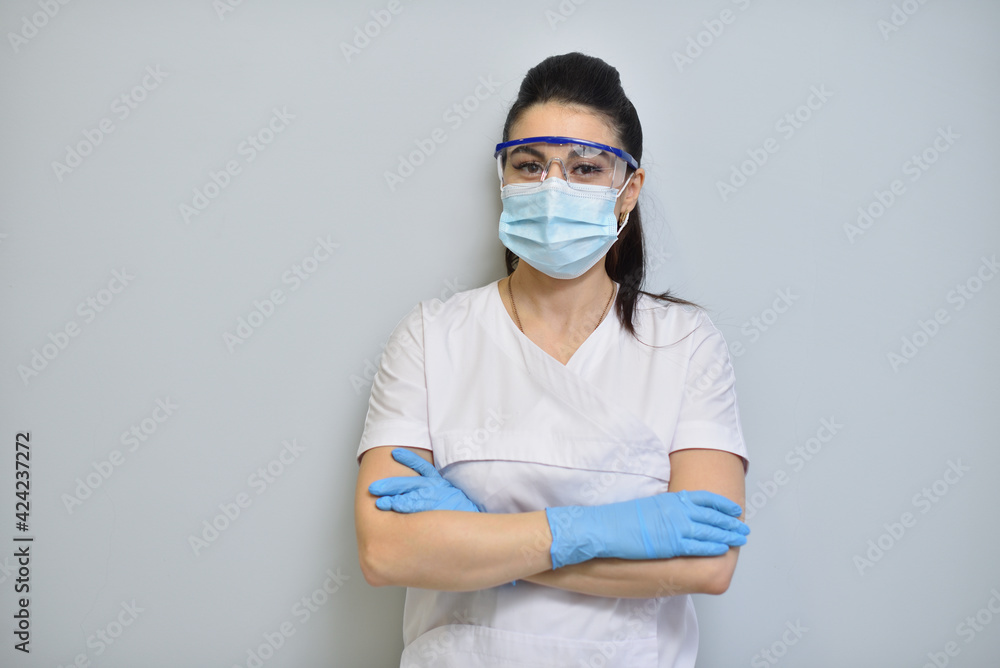 Cute woman dentist in uniform, protective glasses and face mask. Cute woman dentist in uniform, protective glasses and face mask.