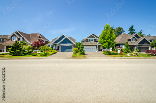 A perfect neighbourhood. Houses in suburb at Summer in the north America. Luxury houses with nice landscape.