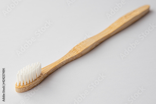 Wooden biodegradable toothbrush on white background