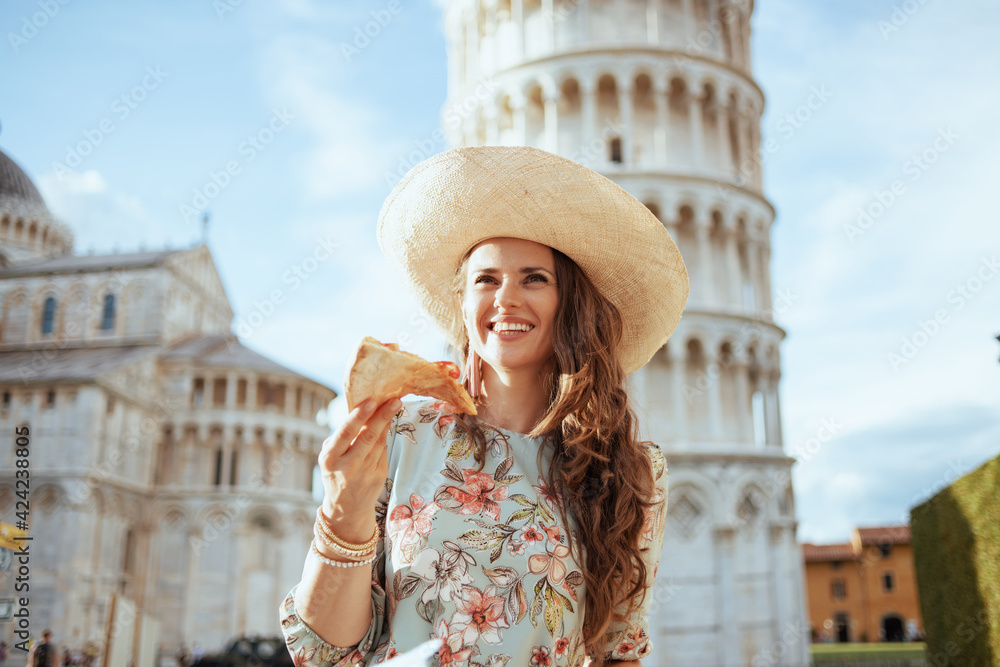 smiling stylish traveller woman in floral dress with pizza