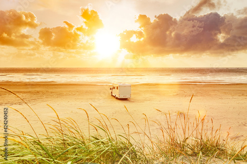 Wohnmobil auf einem Sandstrand am Meer