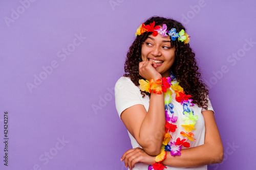 Young Hawaiian woman isolated on purple background relaxed thinking about something looking at a copy space.