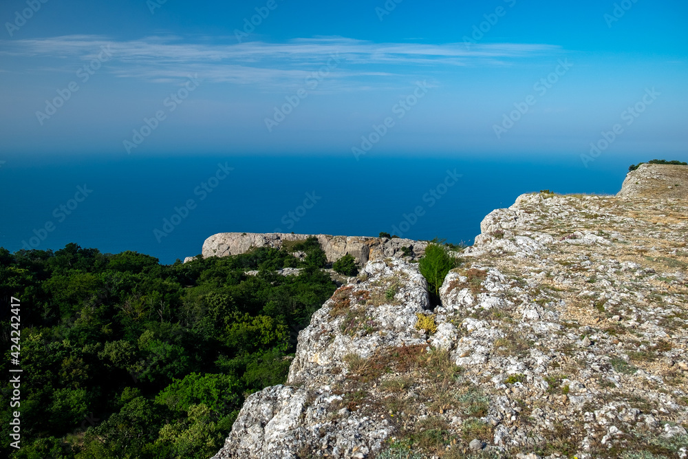 Mediterranean landscape. Forested rocks of the Black Sea coast of the southern coast of the Crimean Peninsula on a clear sunny day. Mediterranean landscape. Forested rocks of the Black Sea coast of the southern coast of the Crimean Peninsula on a clear sunny day.
