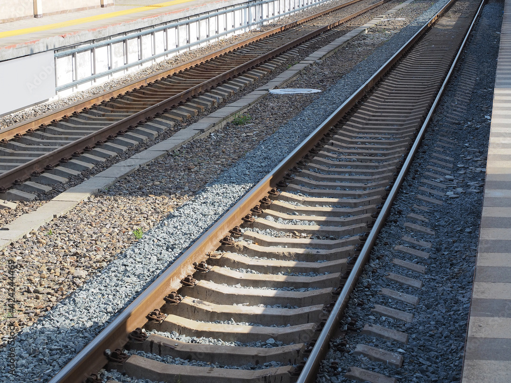 Two parallel railways illuminated by the sun's rays are narrowing in perspective Two parallel railways illuminated by the sun's rays are narrowing in perspective