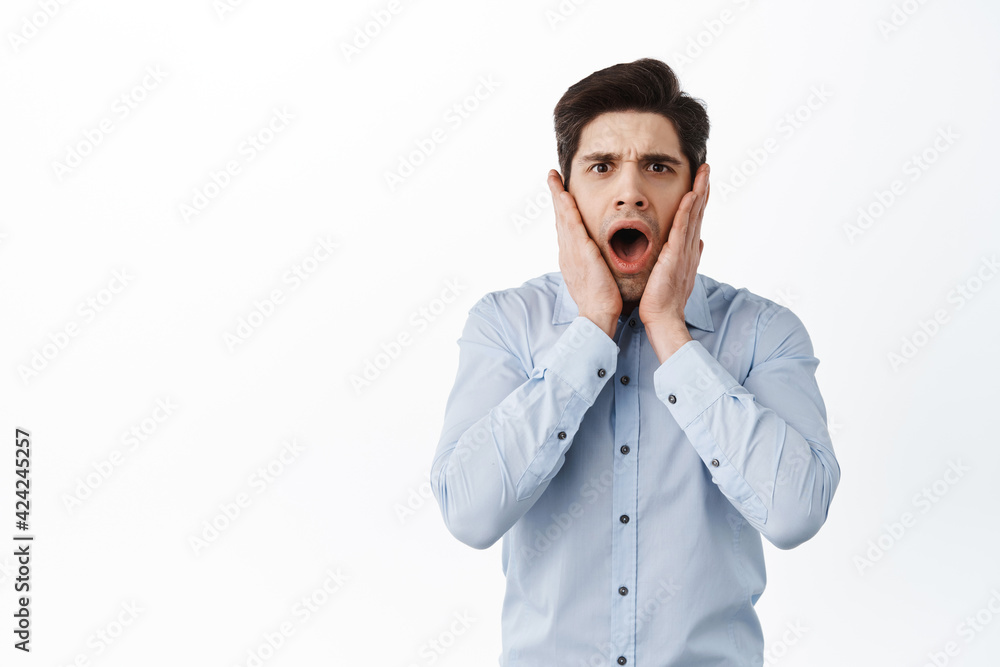 Shocked and distressed office guy, manager screaming and look frustrated, having trouble, panicking, standing over white background Shocked and distressed office guy, manager screaming and look frustrated, having trouble, panicking, standing over white background