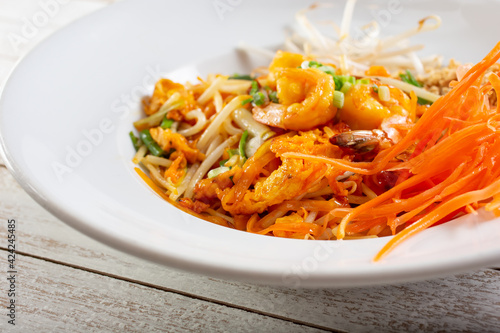 A closeup view of a plate of pad Thai.