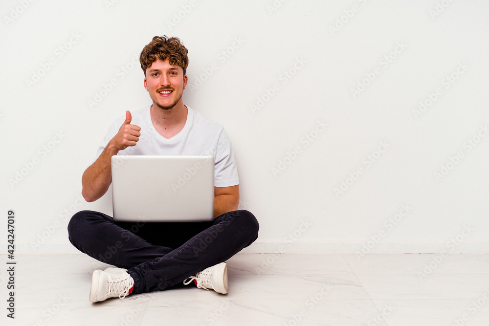 Young caucasian man sitting on the floor holding on laptop isolated on white background Young sport caucasian man isolated on blue background smiling and raising thumb up Young caucasian man sitting on the floor holding on laptop isolated on white background Young sport caucasian man isolated on blue background smiling and raising thumb up