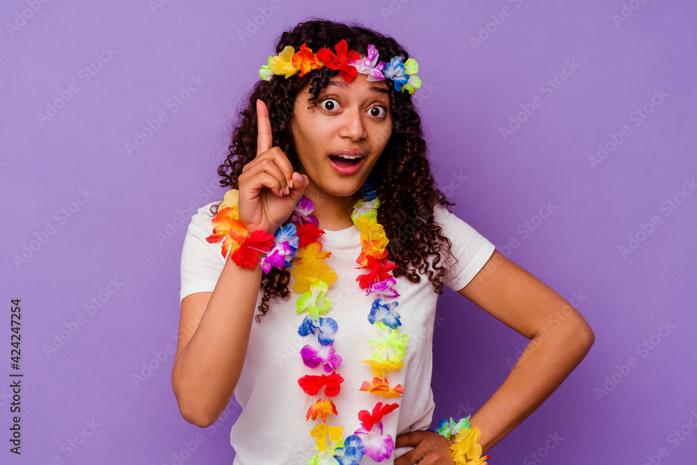 Young Hawaiian woman isolated on purple background having an idea, inspiration concept.