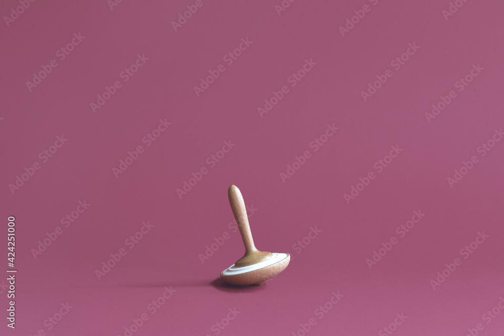 Wooden whirligig made of beech, with ceramic insert, on lilac background. Aroma diffusion device. Copy space. Selective focus. Wooden whirligig made of beech, with ceramic insert, on lilac background. Aroma diffusion device. Copy space. Selective focus.