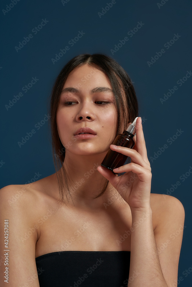 Young girl posing with cosmetic product Young girl posing with cosmetic product