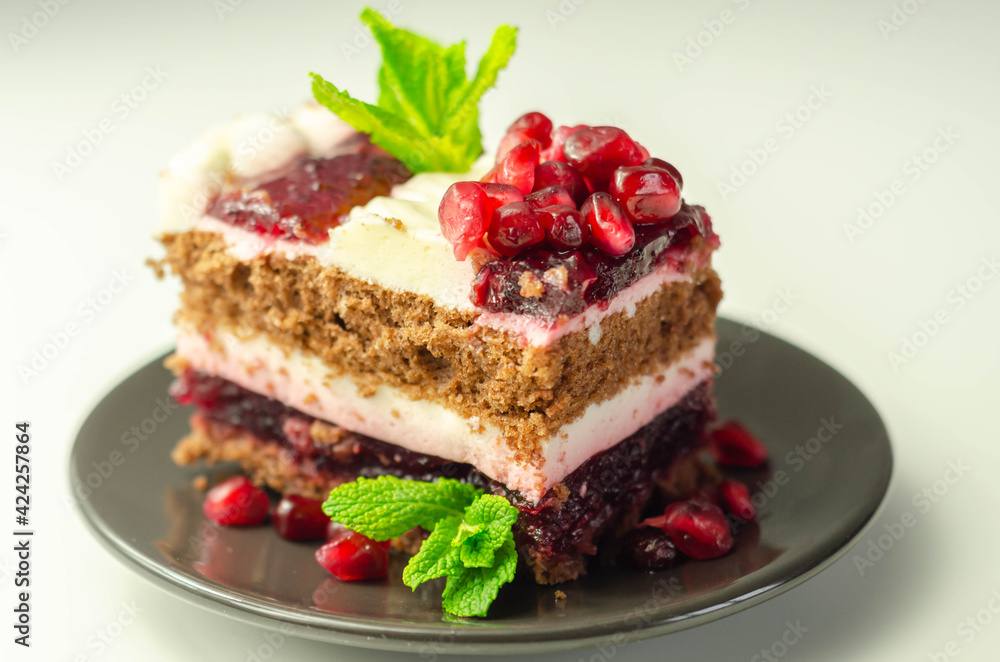 Colorful multi-layered cream chocolate cake with cherry jam and pomegranate Colorful multi-layered cream chocolate cake with cherry jam and pomegranate