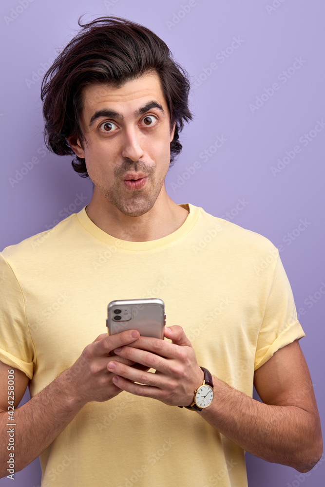 Young Male In Casual Wear Stand With Mobile Phone, Chatting, Reading Message Young Male In Casual Wear Stand With Mobile Phone, Chatting, Reading Message