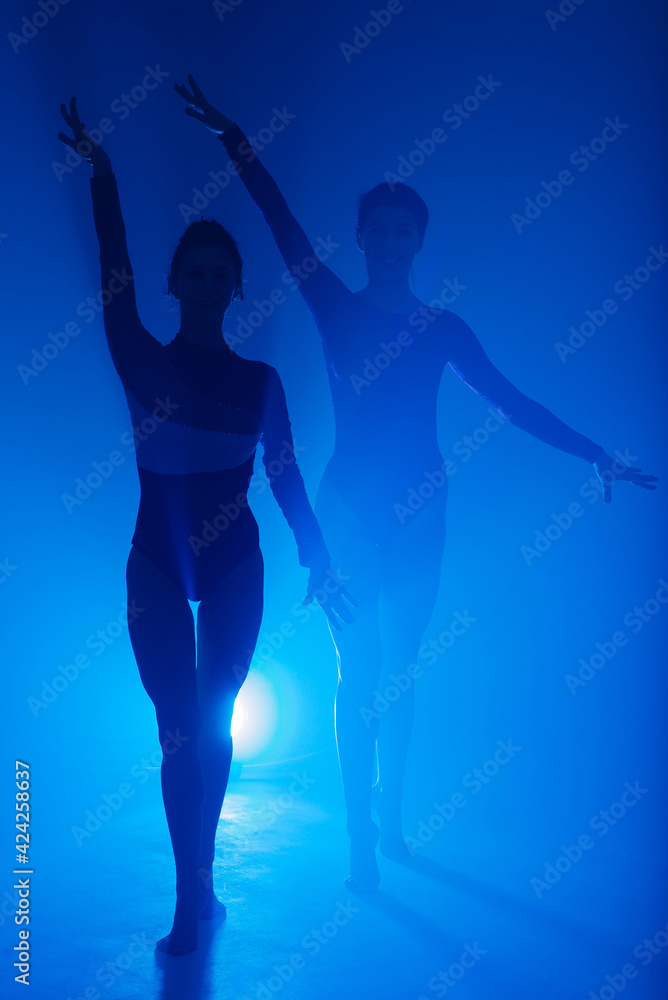 The two modern ballet dancers in black and red bodysuit, studio