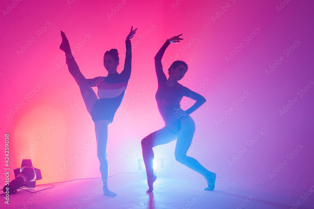 The two modern ballet dancers in black and red bodysuit, studio