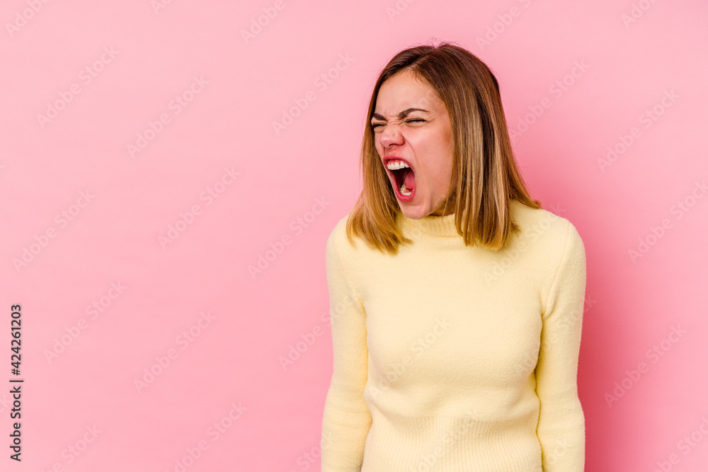 Young caucasian woman isolated on pink background shouting very angry, rage concept, frustrated. Young caucasian woman isolated on pink background shouting very angry, rage concept, frustrated.