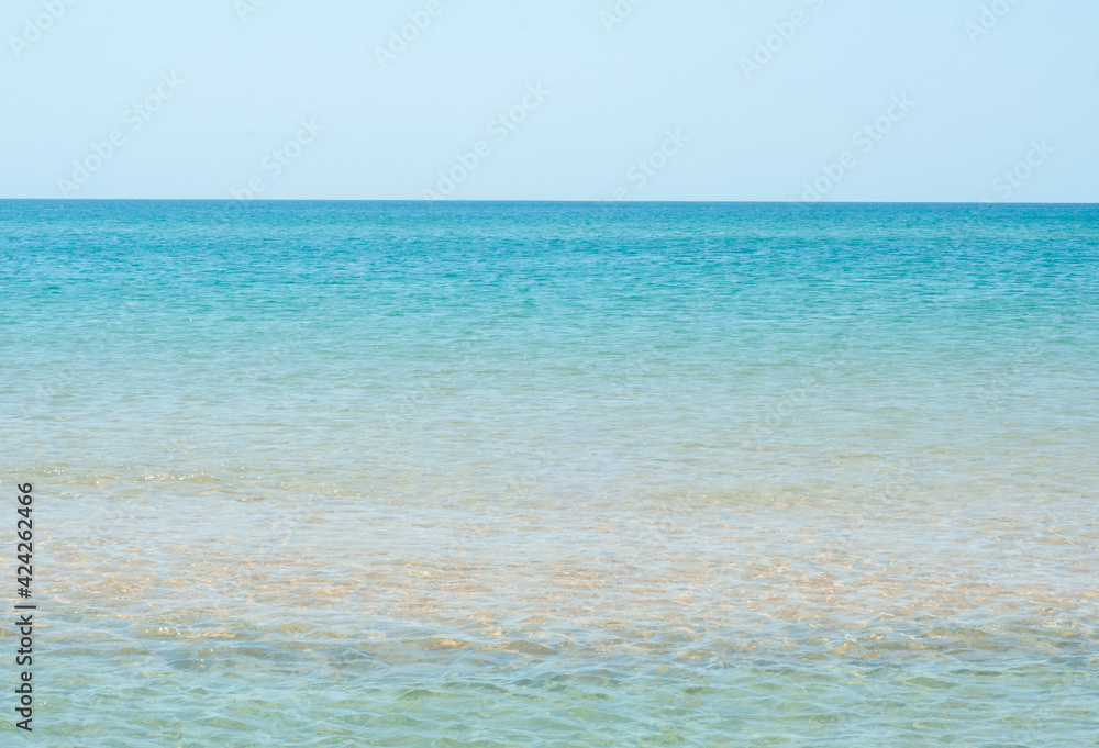 Calm seascape of the coast clear sea on the horizon going into a cloudless sky Calm seascape of the coast clear sea on the horizon going into a cloudless sky