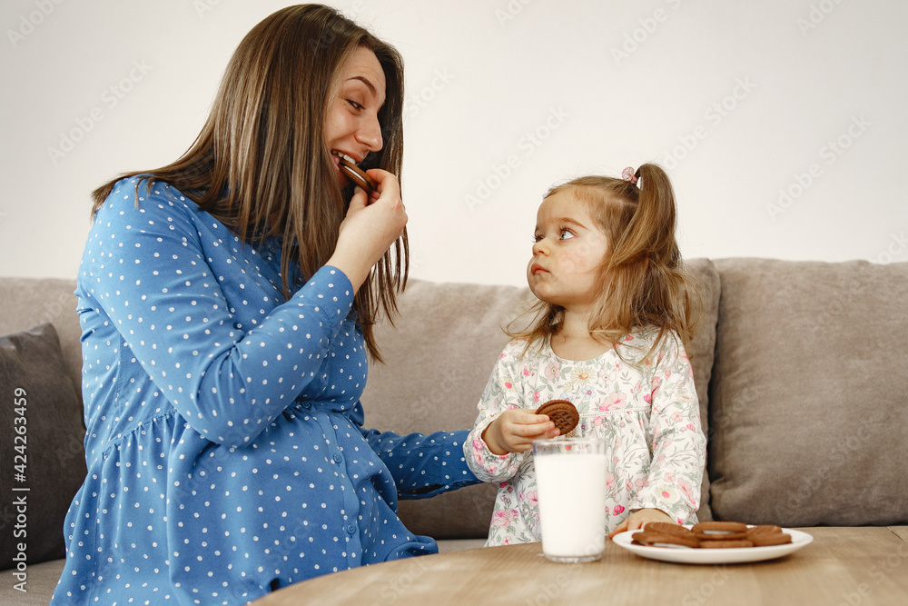 Mother and daughter are treated to cookies and milk Mother and daughter are treated to cookies and milk