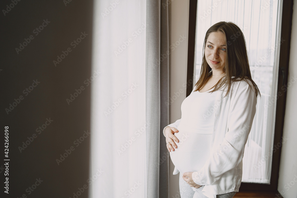 Pregnant woman hugging belly in anticipation of baby Pregnant woman hugging belly in anticipation of baby