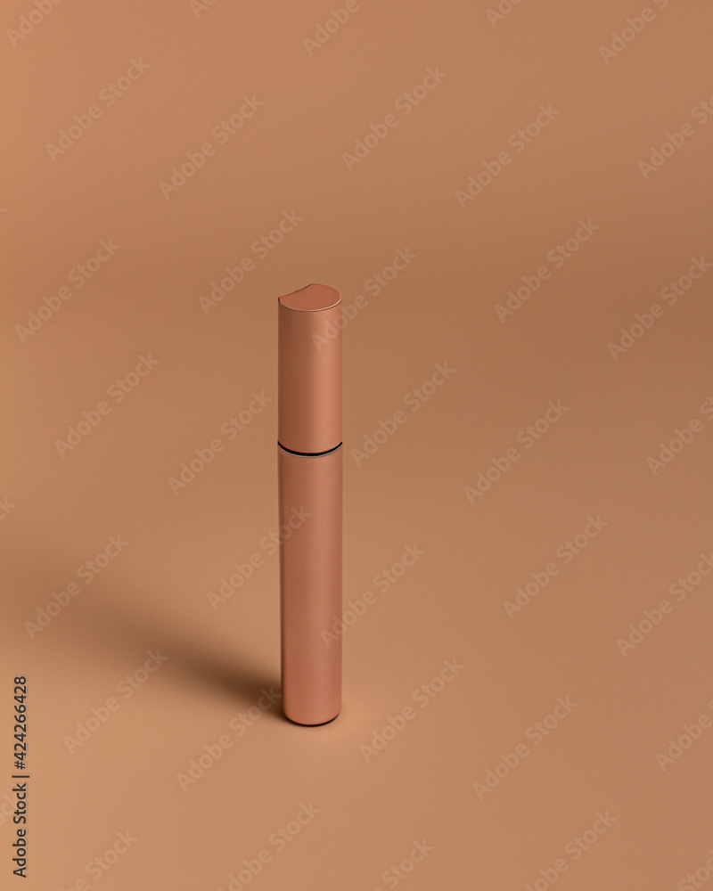 packaging of mascara on a powdery background. Vertical packaging of mascara on a powdery background. Vertical