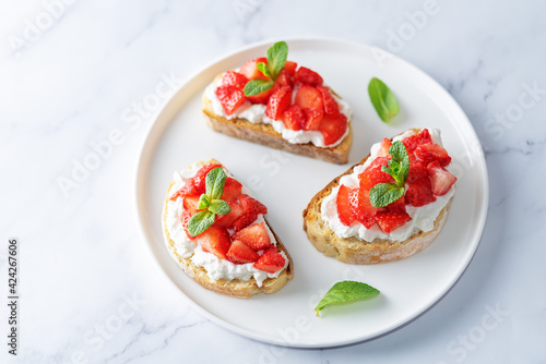 Strawberry ricotta sandwiches with mint leaves