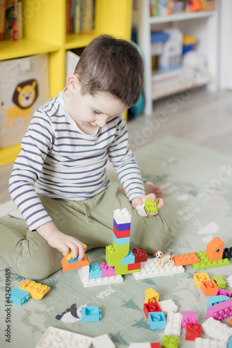 Child playing with colorful toy blocks