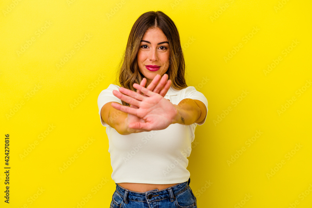 Young caucasian woman isolated on yellow background Young caucasian woman isolated on yellow background
