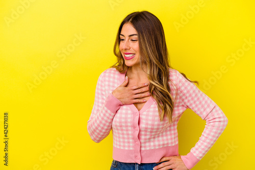 Young caucasian woman isolated on yellow background