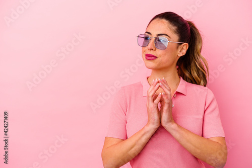 Young caucasian woman isolated on pink background