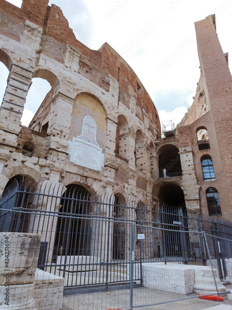 Colosseum entrance arches part view. Iconic ancient monumental 3-tiered Roman amphitheater, gladiatorial games arena in center of Rome, Italy