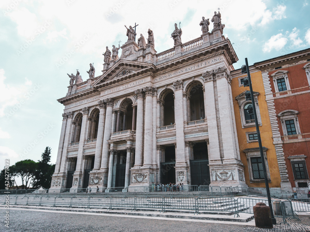 Basilica di San Giovanni in Laterano with ornate white 1700s facade and statues of the Apostles on top in Rome, Italy. Landmark cathedral, the Pope's official seat
