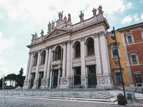 Basilica di San Giovanni in Laterano with ornate white 1700s facade and statues of the Apostles on top in Rome, Italy. Landmark cathedral, the Pope's official seat