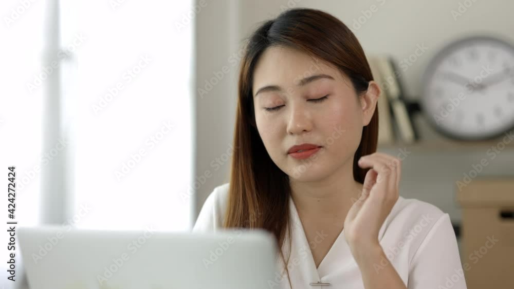 Young asian business woman rubbing her shoulder she's has shoulder, neck pain and hurt get stressed be tired from working with laptop a long time she symptom office syndrome. Young asian business woman rubbing her shoulder she's has shoulder, neck pain and hurt get stressed be tired from working with laptop a long time she symptom office syndrome.
