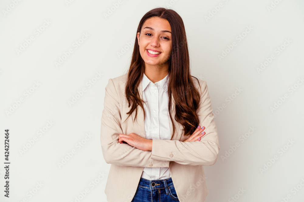 Young Indian business woman isolated on white background who feels confident, crossing arms with determination. Young Indian business woman isolated on white background who feels confident, crossing arms with determination.