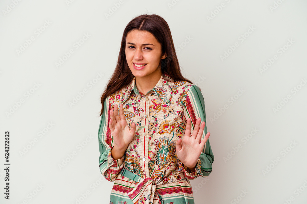 Young Indian woman isolated on white background rejecting someone showing a gesture of disgust. Young Indian woman isolated on white background rejecting someone showing a gesture of disgust.