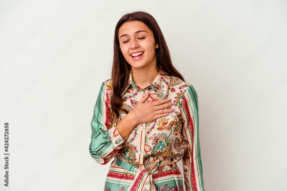 Young Indian woman isolated on white background laughs out loudly keeping hand on chest. Young Indian woman isolated on white background laughs out loudly keeping hand on chest.