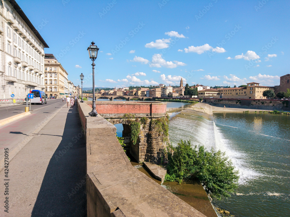 View on Florence city center from river embankment. River Arno cascade. Travel Italy