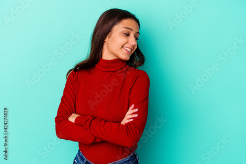 Young Indian woman isolated on blue background laughing and having fun.