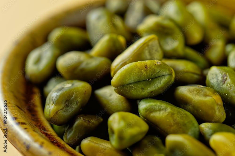 Close up of green pistachios in a bowl Close up of green pistachios in a bowl