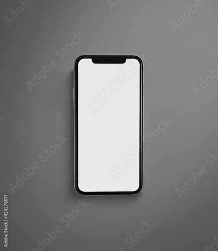 Smartphone simile ad iPhone con schermo bianco per mockup infografiche, Marketing Plan, scontornato con sfondo grigio cemento. photo