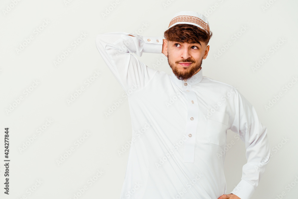 Young Arab man wearing the typical arabic costume isolated on white background touching back of head, thinking and making a choice. Young Arab man wearing the typical arabic costume isolated on white background touching back of head, thinking and making a choice.