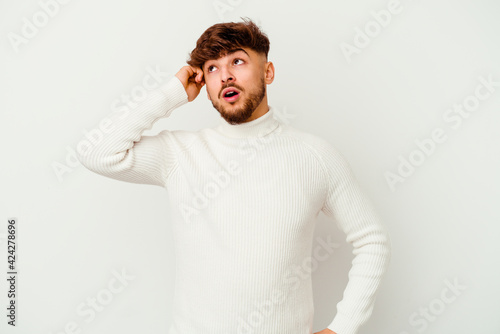 Young Moroccan man isolated on white background being shocked, she has remembered important meeting. photo