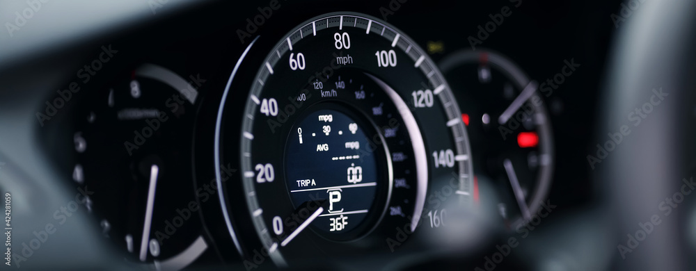 Miles Speedometer of Modern car close up. Modern car speedometer. Panoramic shot of the dashboard a car.