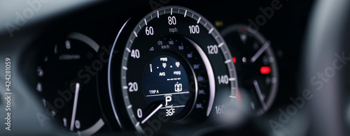 Miles Speedometer of Modern car close up. Modern car speedometer. Panoramic shot of the dashboard a car. © kucheruk