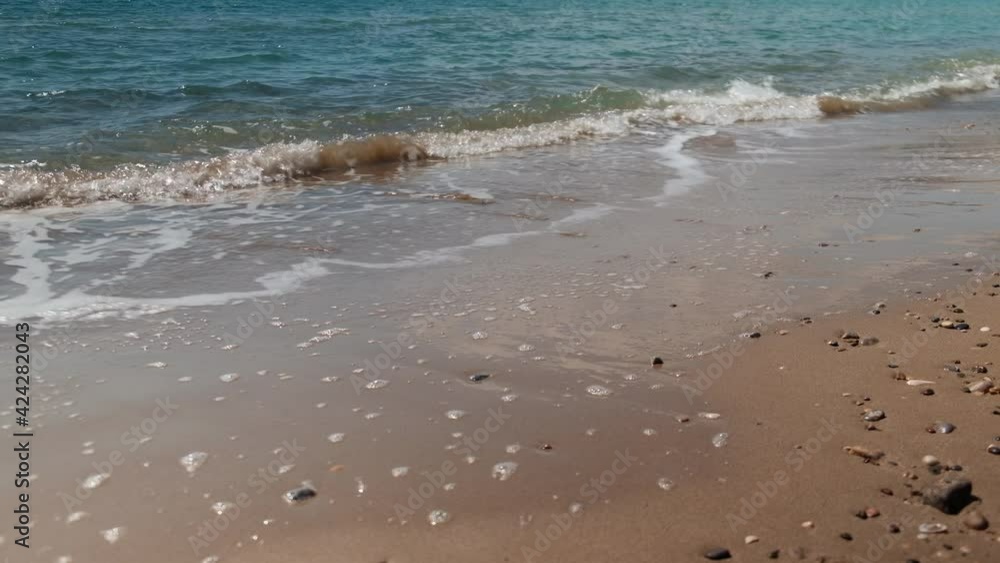 Splashing waves of sea and sandy beach. Close-up of evening surf waves Splashing waves of sea and sandy beach. Close-up of evening surf waves