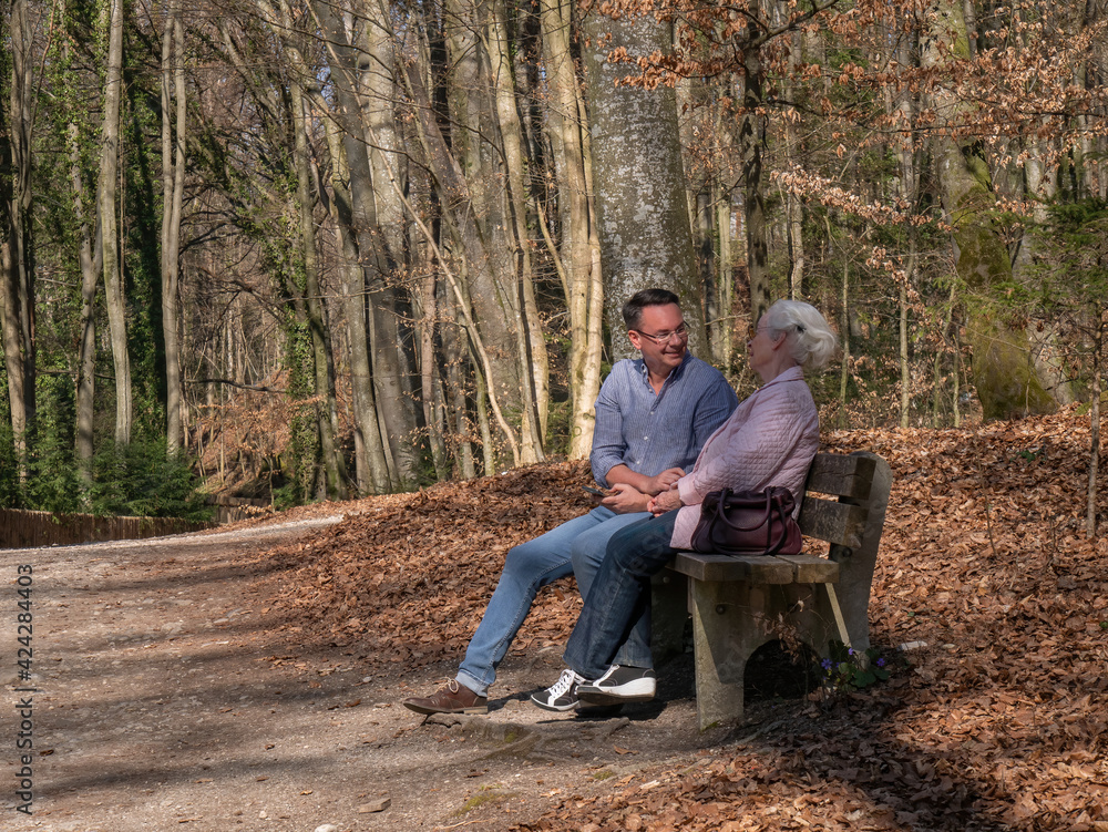 Senior mother and her son sitting in the park Senior mother and her son sitting in the park