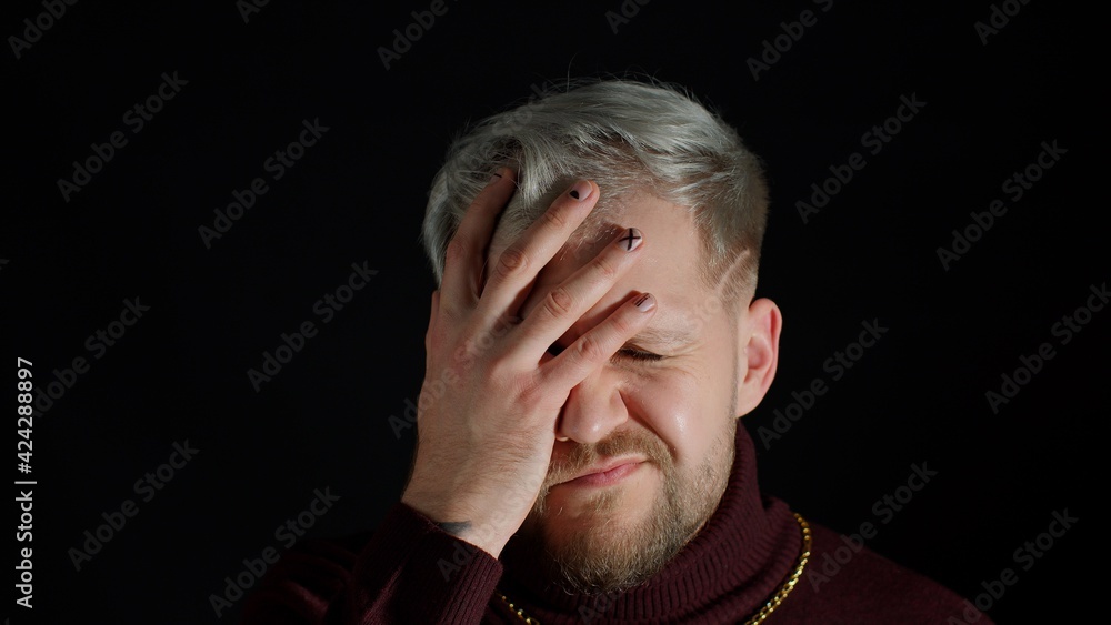 Disappointed handsome man doing face palm gesture on black background. Stressed guy covering face with hand. Facial expression of trendy bearded guy with gray hair. People lifestyle. Modern fashion Disappointed handsome man doing face palm gesture on black background. Stressed guy covering face with hand. Facial expression of trendy bearded guy with gray hair. People lifestyle. Modern fashion
