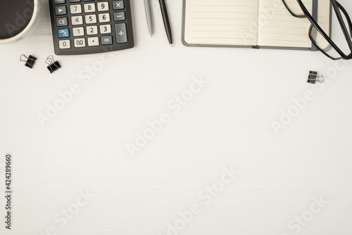Fotografie Top view photo of business workplace with glasses binders pens planner cup of co